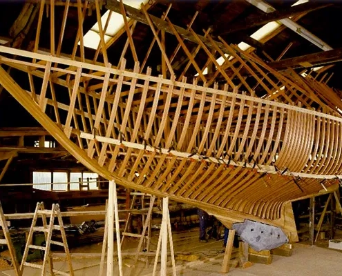 Holzskelett eines Schiffsrumpfes während des Bootsbaus in einer Werft.